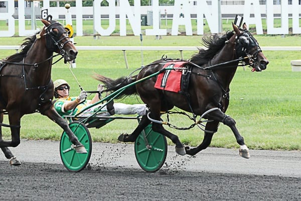 Tetrick (shown winning the Cane Pace with Huntsville on Hambletonian Day at the Meadowlands) said he isn't a fan of those that tell him he shouldn't be able to lean back in the sulky, especially since that style has proven to be effective | Michael Lisa
